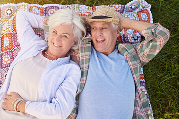 Wall Mural - This is one relaxing retirement. Portrait of a happy senior couple relaxing together on the lawn.