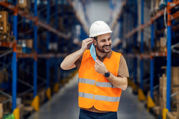 Sticker - A happy warehouse worker putting on mask during corona virus.