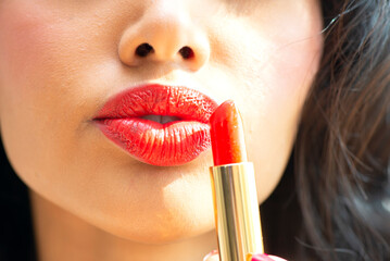 woman putting on lipstick,Red lipstick lips with pink lipstick and Trendy colourful.