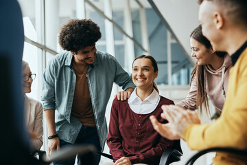 Wall Mural - Young happy woman receives support from attenders of group therapy at mental health center.