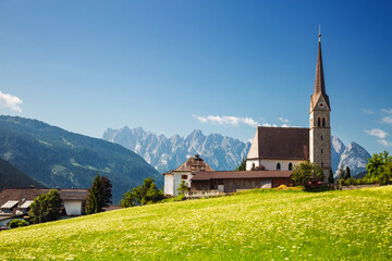 Fototapete - Picturesque touristic alpine village with catholic church on a sunny day. Gosau village, Upper Austria.