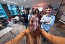 Group Of Business People During Break From The Work Taking Selfie Picture While Enjoying Free Time In Relaxation Area At Modern Open Plan Startup Office. Selective Focus 