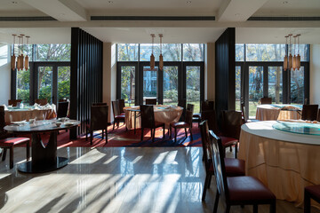 Chinese hotel lobby design, morning sunlight through the carved Windows, there are Chinese desks and chairs and sofas in the inside.