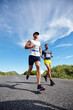 © Daniel Laflor/peopleimages.com - Hes catching up. Shot of a group of young men running a marathon.