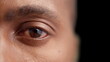 © Synthex🇺🇦 - Black man opening eye on dark background, eyesight examination, optometry