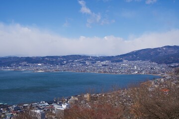 Wall Mural - The view of Lake Suwa with cloud in winter.