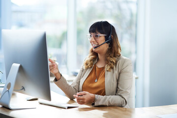 Poster - I have a solution for you. Cropped shot of an attractive young businesswoman sitting and using a headset in her office during the day.