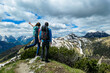 © Chris - Active couple hiking on Frauenkogel with scenic view on mountain peaks in the Karawanks, Carinthia, Austria. Border with Slovenia. Triglav National Park. Kahlkogel (Golica). Snow melting in spring