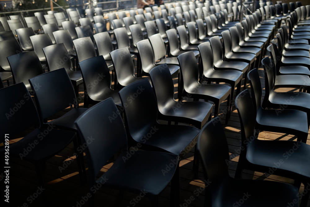 Many Black Chairs in a Row. evocative series of chairs. rows of chairs ...