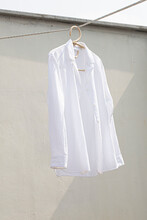 White Shirt Hanging To Dry On Clothes Line