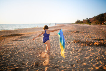 Wall Mural - Cute european child teen girl run along the beach by the sea, happy childhood and freedom. Plus size kid, overweight and sports by the sea