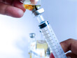 © Suranto - Vaccine medicine bottles and syringes for health industry background.