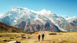 A couple walking on the Annapurna Circuit Trek, Himalayas, Nepal. Snow caped Annapurna chain in the back. Clear weather, dry grass, snowy peaks. High altitude, massive mountains. Freedom and adventure