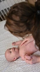 mother bonding and playing with her adorable baby boy at home