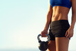 © Anne B/peopleimages.com - When it comes to fitness theres no time like now. Cropped shot of a sporty young woman holding a kettle bell outdoors.