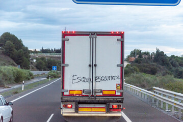 Canvas Print - Refrigerator truck seen from behind with a graffiti that says scab (strike-breaker), working in times of transport strike.