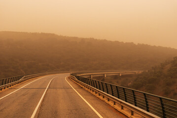 Wall Mural - Viaduct between mountains with a lot of saharan dust in the environment (calima)