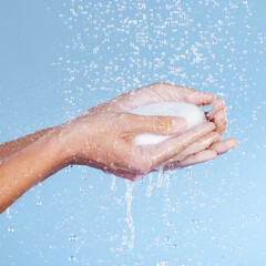 Sticker - Water and soap are your best friends. Studio shot of an unrecognisable woman holding a bar of soap while taking a shower against a blue background.