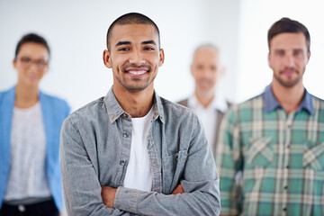 Poster - Im in the right place, at the right time. Young businessman smiling confidently with colleagues in the background.