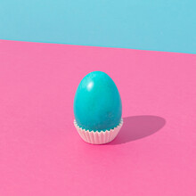 Cyan Easter Egg Against Bold Pink And Cyan Background. Minimal Easter Concept. Fun Food Idea.