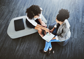 Aufkleber - Getting together for another effortless collaboration. High angle shot of two businesswomen working together on a digital tablet in an office.