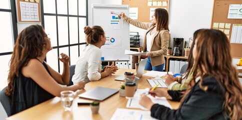 Canvas Print - Group of young businesswomen listening boss conference during meeting at the office.