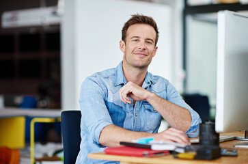 Poster - Hes got the confidence to get the job done. Portrait of a handsome young man sitting at his desk in an office.