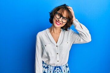 Poster - Young brunette woman wearing casual clothes and glasses confuse and wonder about question. uncertain with doubt, thinking with hand on head. pensive concept.