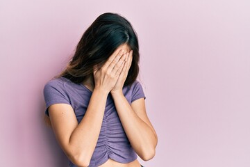 Wall Mural - Young caucasian woman wearing casual clothes with sad expression covering face with hands while crying. depression concept.