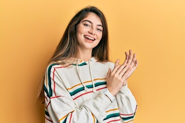 Poster - Young caucasian woman wearing casual clothes clapping and applauding happy and joyful, smiling proud hands together