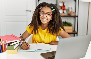 Sticker - Young african american girl doing homework at home with a happy and cool smile on face. lucky person.