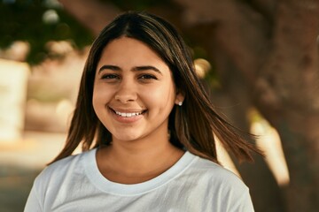 Poster - Young latin girl smiling happy standing at the park.