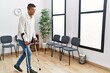 © Krakenimages.com - Young hispanic man waiting wearing crutches at waiting room