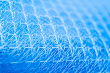 Background Texture Closeup Of Blue Netting. Abstract Background With Intersection Of Nylon Threads At High Magnification.
