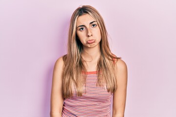 Wall Mural - Beautiful hispanic woman wearing casual summer t shirt depressed and worry for distress, crying angry and afraid. sad expression.