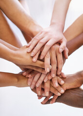 Sticker - Showing solidarity. Shot of a group of people putting their hands together.