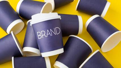 Wall Mural - coffee branding mockup, blue paper coffee cup with brand word on yellow background