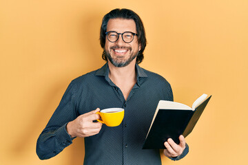 Sticker - Middle age caucasian man reading book drinking cup of tea smiling with a happy and cool smile on face. showing teeth.