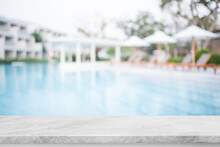 Empty White Marble Stone Table Top And Blurred Swimming Pool In Tropical Resort In Summer Banner Background - Can Used For Display Or Montage Your Products.