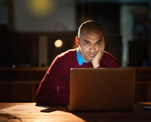 Aufkleber - Late nights can be so boring. Sho of a young man looking bored while working late in his office.