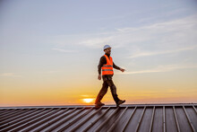 A Happy Construction Worker Walking On Roof On His Way To Build.