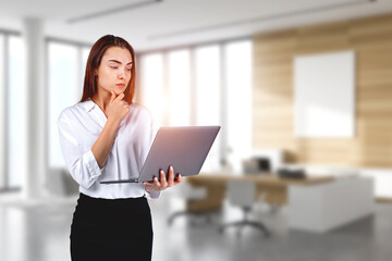 Poster - Young attractive businesswoman wearing formal suit is holding la