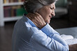 Close up unhealthy old 60s woman suffer from neckache, pinched nerves, massaging stiff sore neck or tensed muscles relieving painful feelings. Incorrect posture, fibromyalgia, chronic diseases concept
