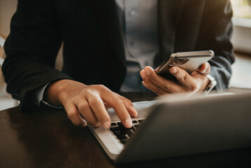 hand using smart phone payments online shopping, omni channel, digital docking keyboard computer.