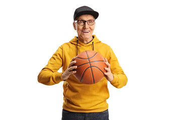 Wall Mural - Smiling elderly man in a yellow sweathsirt holding a basketball