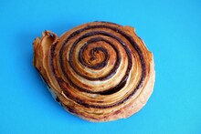 Traditional Popular Hungarian Sweet Pastry Called Cocoa Snail Named "kakaos Csiga"  On A Light Blue Background
