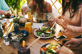 Fototapeta Londyn - Young friends having fun eating brunch at healthy food restaurant - Focus on right girl hand