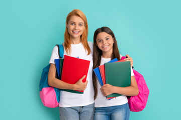 Wall Mural - cheerful mother and daughter hold notebook and backpack ready to study, learning