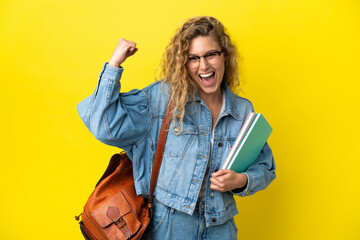 young student caucasian woman isolated on yellow background doing strong gesture