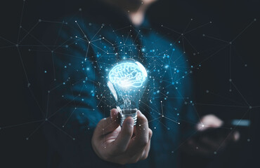 businessman hand holding lightbulb with glowing virtual brain and connection line to creative smart 